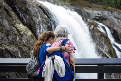 Grandmother and granddaughter admiring waterfall