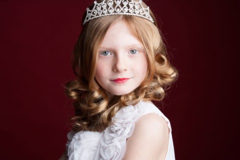 Caucasian girl wearing tiara and princess costume