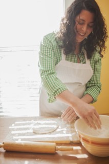 Baker rolling dough on counter