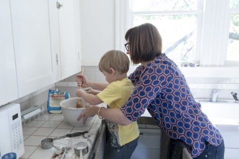 Mother and son baking in kitchen