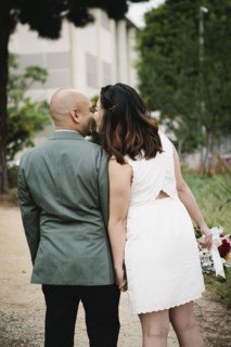 Japanese newlywed couple kissing outdoors