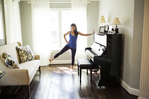 Woman stretching at window