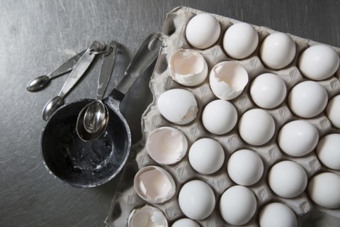 Carton of eggs with measuring spoons