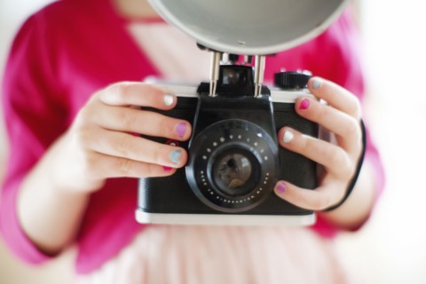 Close up of girl holding camera