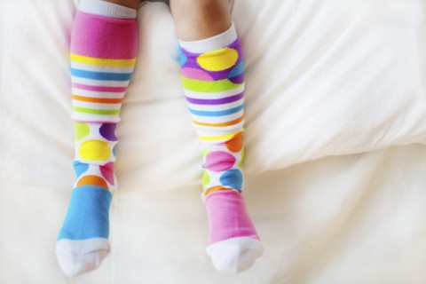 Close up of child wearing colorful socks