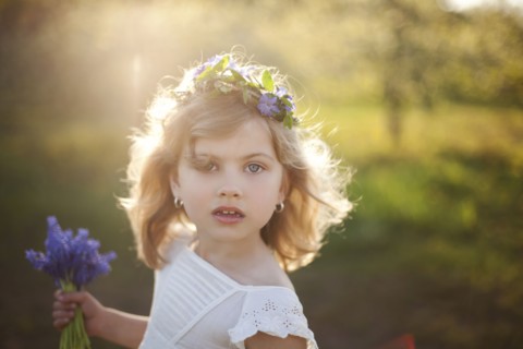 Caucasian girl carrying flowers outdoors