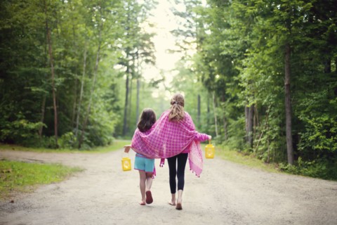 Caucasian sisters walking on dirt road