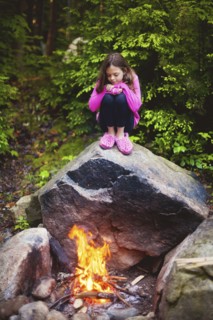 Caucasian girl admiring campfire