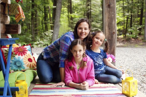 Caucasian mother and daughters smiling on porch