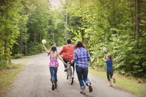 Three generations of Caucasian women walking on dirt road