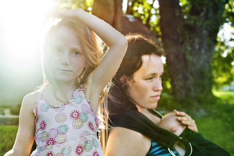 Serious mother and children outdoors