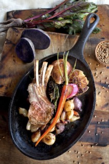 Pan of roasted rack of ribs and vegetables