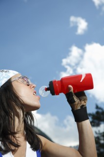 Caucasian woman drinking water bottle outdoors