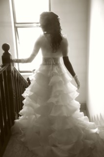 Rear view of bride walking down staircase
