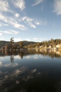 Blue sky and hills reflecting in remote lake