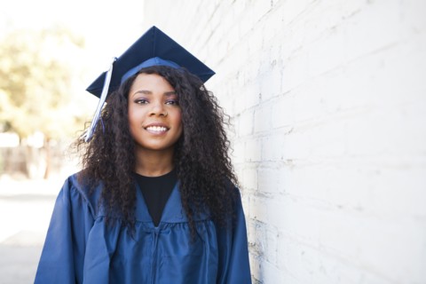 Black graduate wearing cap and gown