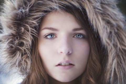 Close up of woman wearing fur hood
