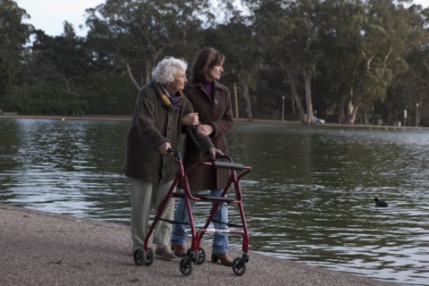 Woman walking with mother at pond