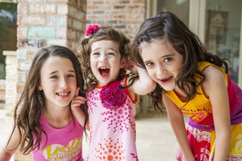 Playful sisters smiling outdoors