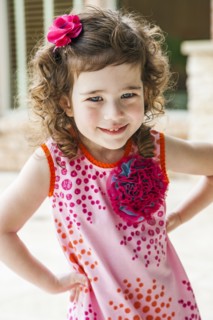 Smiling girl with hands on hips