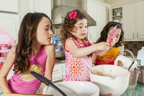 Sisters baking in kitchen