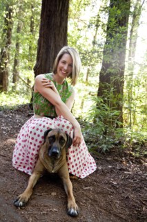 Mixed race woman and dog in forest