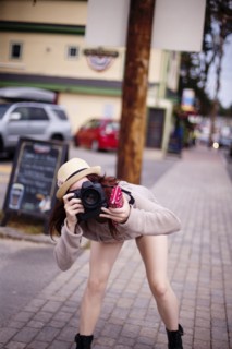 Caucasian woman photographing outdoors