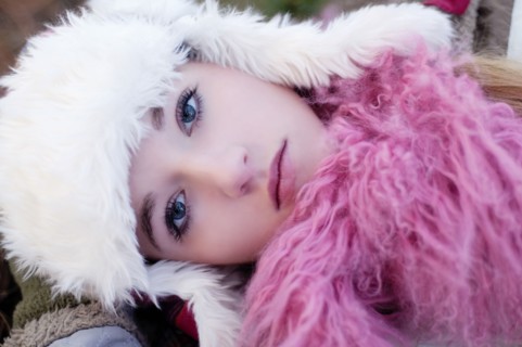 Caucasian teenage girl wearing fuzzy hat