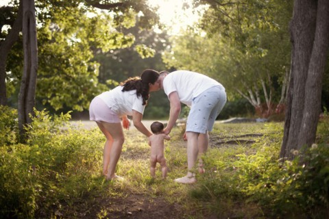 Parents and baby walking in garden