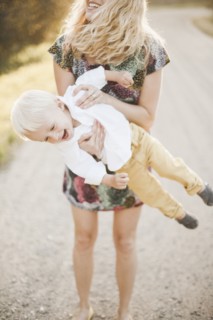Mother lifting son outdoors