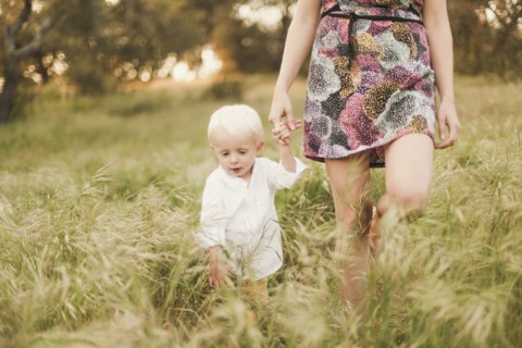 Mother and son walking in field