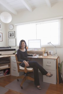 Hispanic woman working in home office