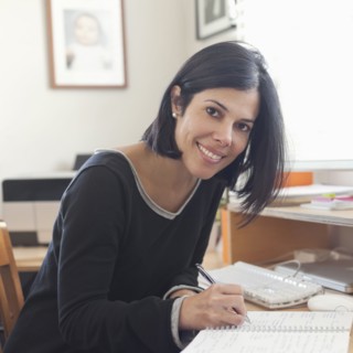 Hispanic woman working in home office