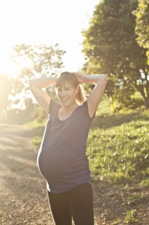 Pregnant Caucasian woman exercising outdoors