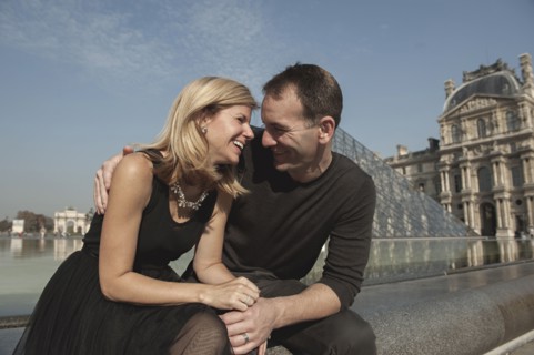 Caucasian couple laughing near fountain
