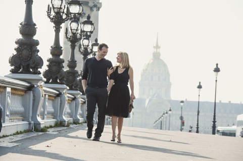 Caucasian couple walking on urban bridge