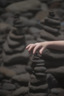 Close up of hand stacking rocks
