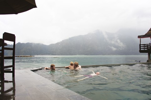 Caucasian children admiring scenic view from swimming pool