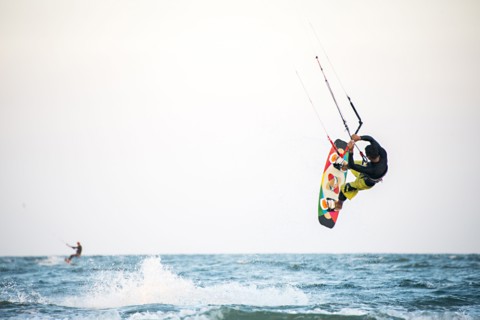 Man kiteboarding over ocean waves