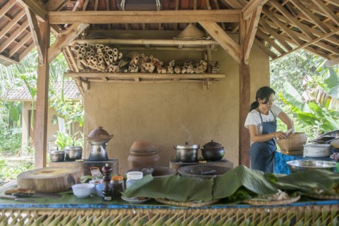 Asian chef cooking in outdoor kitchen
