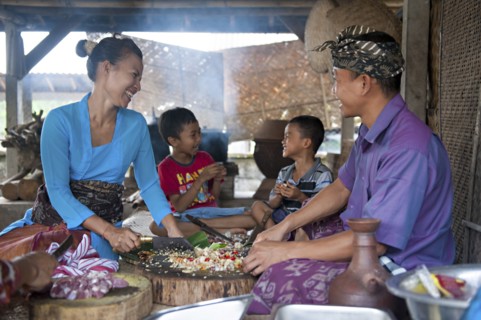 Asian family cooking together in outdoor kitchen