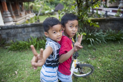 Asian boys playing in backyard
