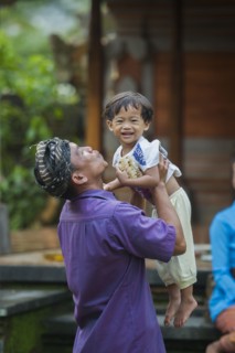 Asian father playing with son outdoors