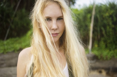 Serious Caucasian woman standing on beach