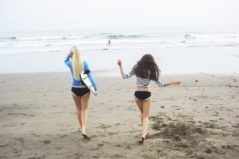 Caucasian women walking on beach