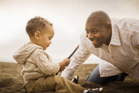 Father and son playing on beach