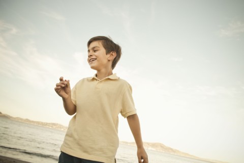 Mixed race boy enjoying beach