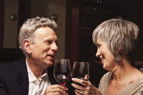 Couple toasting with red wine in restaurant