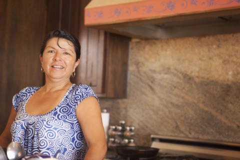 Hispanic woman standing in kitchen
