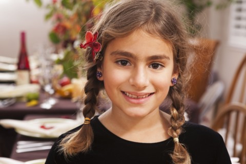 Smiling Hispanic girl at Thanksgiving dinner